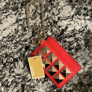 Orange Michael Kors wallet/ wristlet with gold studs on the front